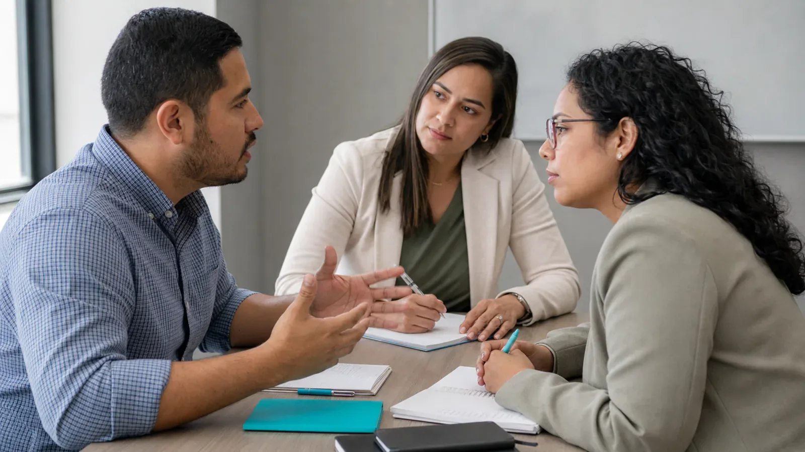 Two participants practice a customer conversation while a sales coach offers feedback.