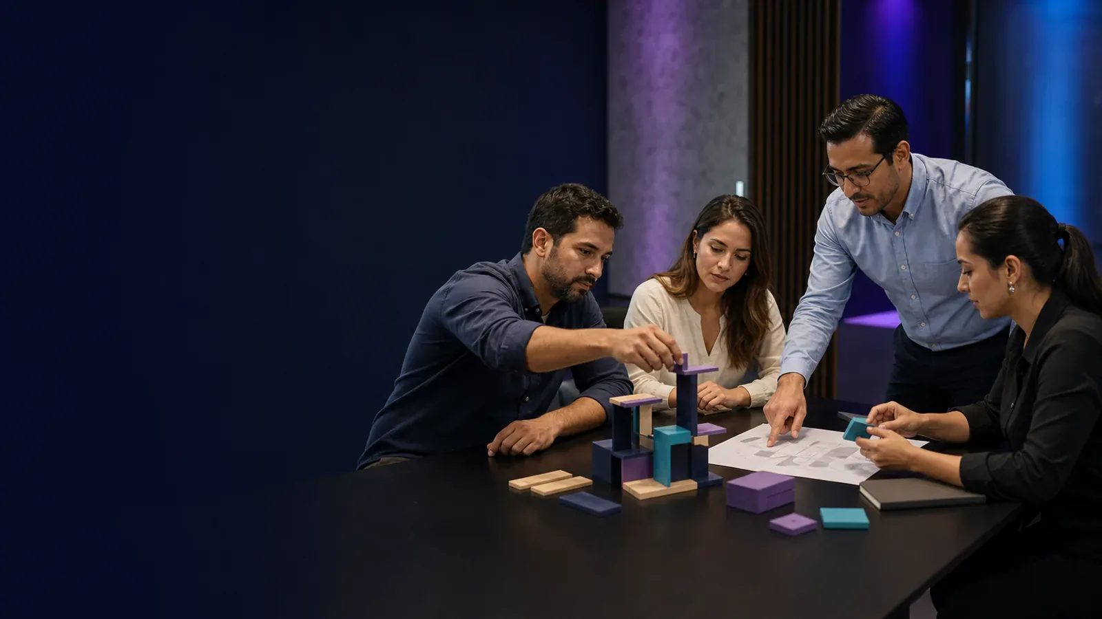 Four Latin American professionals collaborate to build a modular structure during a team-building challenge.