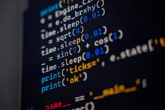 Programming code with syntax highlighting on a dark screen, showing Python functions and variables.