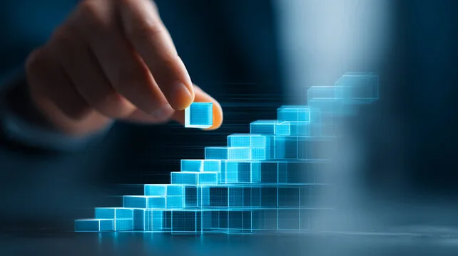 Hand placing a glowing blue block onto an ascending staircase of blocks, symbolizing growth and progress.