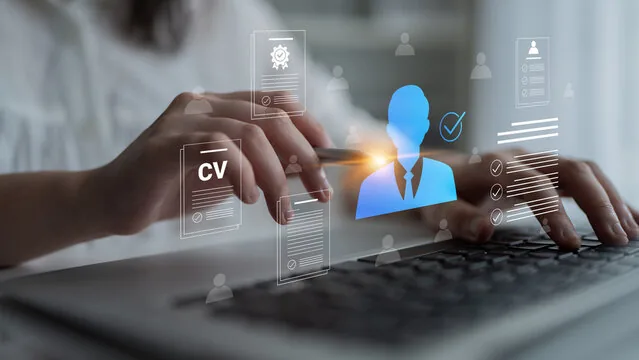 Hands typing on a keyboard with floating CV and candidate profile icons, representing human resource management.